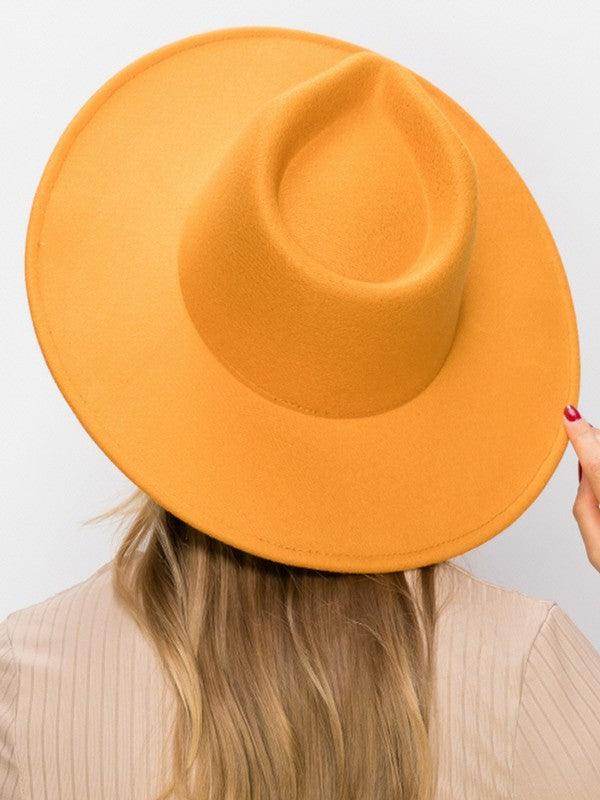 Stylish vegan panama hat in vibrant orange, perfect for summer outfits and sun protection.