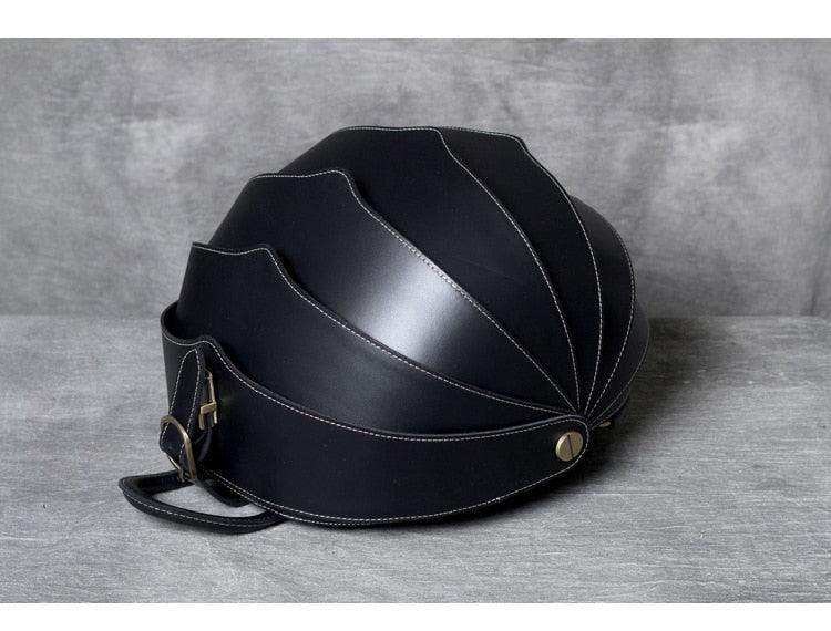 Accordion beetle daypack in sleek black design with unique shell-inspired shape for stylish travel