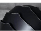 Close-up of Accordion Beetle Daypack in sleek black design with unique wave pattern