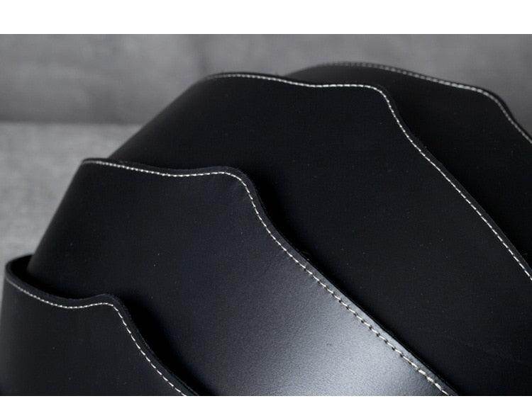Close-up of Accordion Beetle Daypack in sleek black design with unique wave pattern