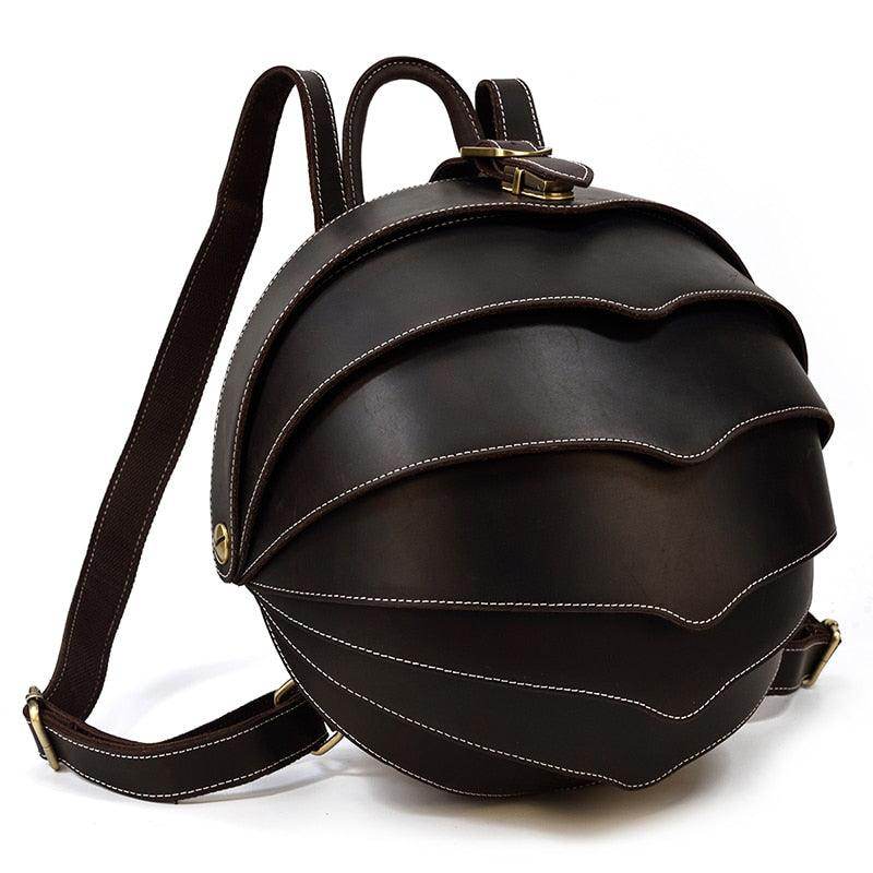 Accordion beetle daypack in dark brown leather with unique curved design and adjustable straps
