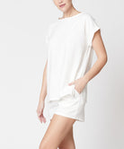 Woman wearing a white bamboo linen shorts set with a loose fit top and comfortable shorts