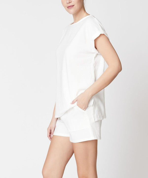 Woman wearing Fabina white bamboo linen shorts set with short sleeves and side pockets