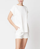 Woman wearing Fabina white bamboo linen shorts set with short sleeves and relaxed fit