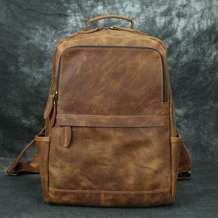 Brown leather overnight bag with multiple compartments for travel convenience