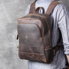 Brown leather overnight bag with multiple pockets and adjustable straps for convenient travel