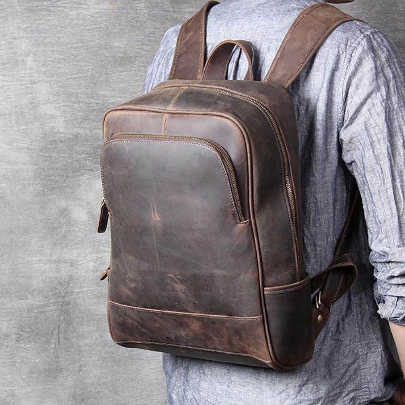 Brown leather overnight bag with multiple pockets and adjustable straps for convenient travel