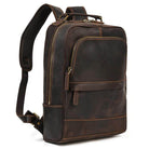 Brown leather overnight bag with adjustable straps and multiple pockets for travel convenience