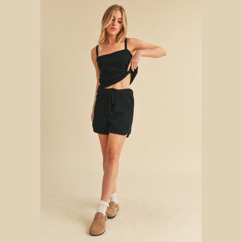 Woman wearing black casual tank and shorts set from Aemi Co with drawstring waist and comfortable fit