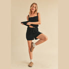 Woman wearing black casual tank and shorts set from Aemi Co with comfortable fit and stylish design