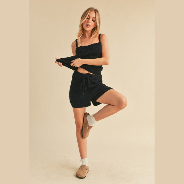 Woman wearing black casual tank and shorts set from Aemi Co with comfortable fit and stylish design