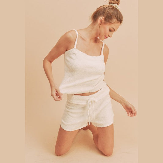 Woman wearing white casual tank and shorts set by Aemi Co with a soft textured fabric