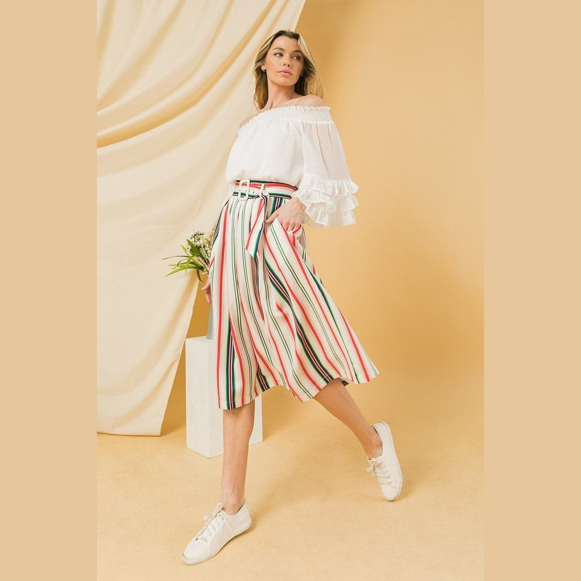Colorful striped vacation skirt by VacationGrabs worn with white off-shoulder blouse and sneakers