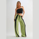 VacationGrabs comfortable wide leg lounge trousers in green with black side stripes worn by woman