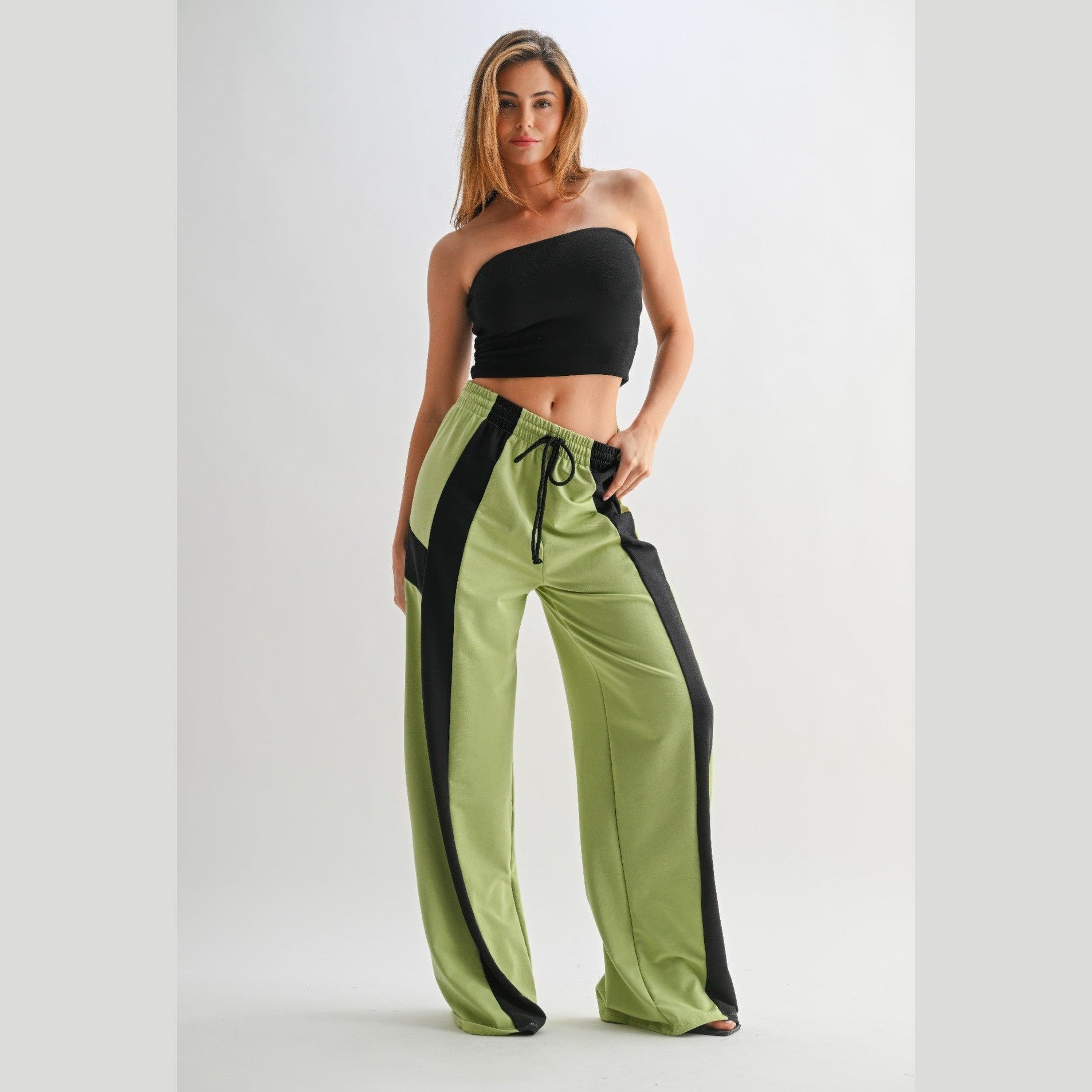 VacationGrabs comfortable wide leg lounge trousers in green with black side stripes worn by woman