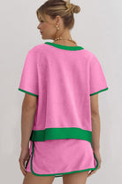 YNIQUE drop shoulder casual summer set in pink with green trim worn by woman shown from back
