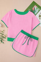 YNIQUE drop shoulder casual summer set in pink with green trim short sleeve top and matching shorts