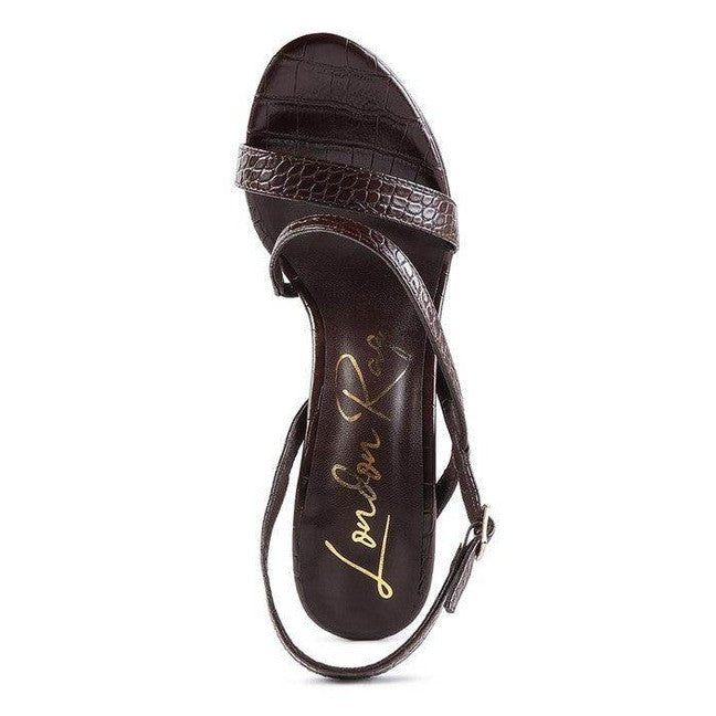 Brown elegant high heeled sandals with a stylish croc pattern and adjustable ankle strap