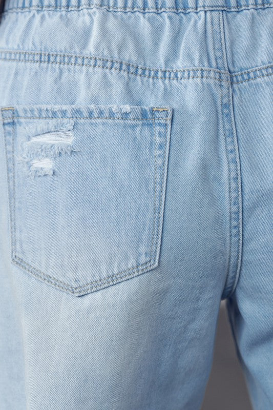 Close-up of back pocket on light wash frayed hem drawstring jean shorts by Denim Lab USA