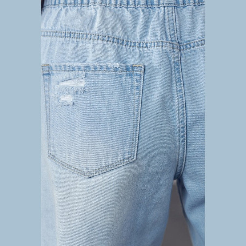 Close-up of back pocket on light wash frayed hem drawstring jean shorts by Denim Lab USA