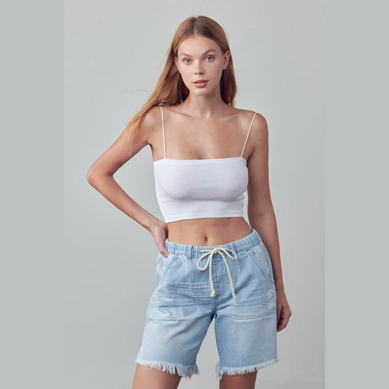 Denim Lab USA frayed hem drawstring jean shorts in light blue worn by woman with white crop top