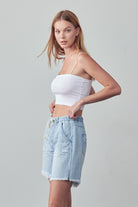 Denim Lab USA women's frayed hem drawstring jean shorts in light blue worn with white crop top
