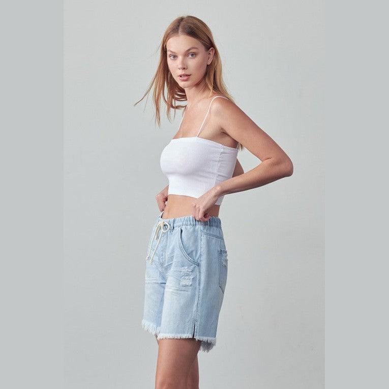 Denim Lab USA women's frayed hem drawstring jean shorts in light blue worn with white crop top