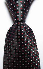 Stylish black necktie with red and silver square pattern, part of a gold green necktie set
