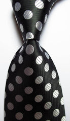 Elegant gold green necktie set with shiny silver polka dots on a black background