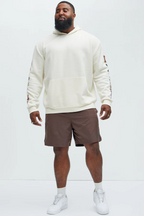 Men's hustle daily hoodie for vacation in white by VacationGrabs worn with brown shorts and white sneakers