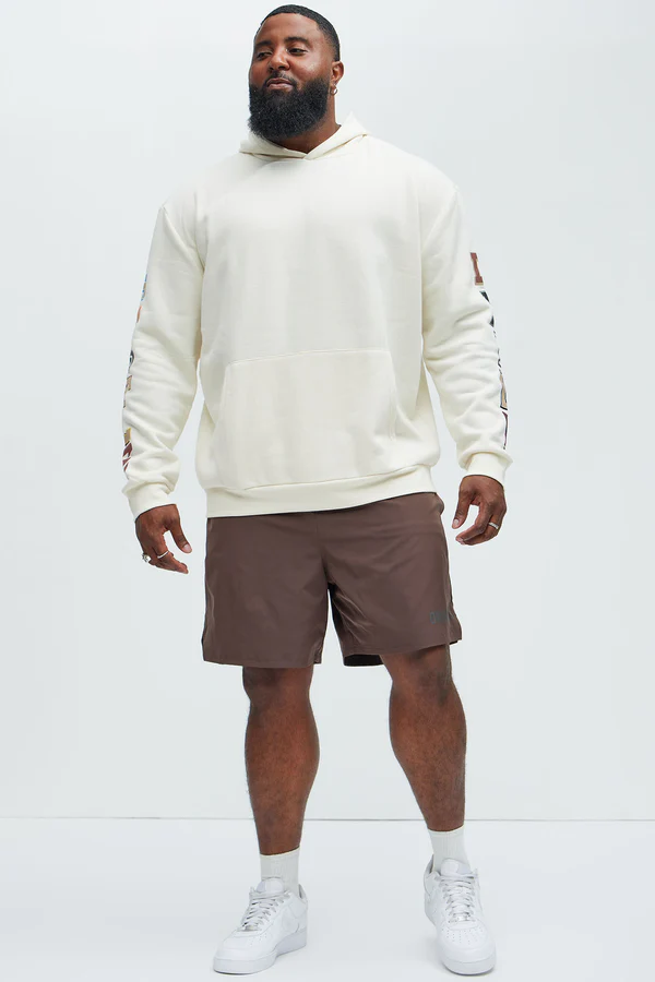 Men's hustle daily hoodie for vacation in white by VacationGrabs worn with brown shorts and white sneakers