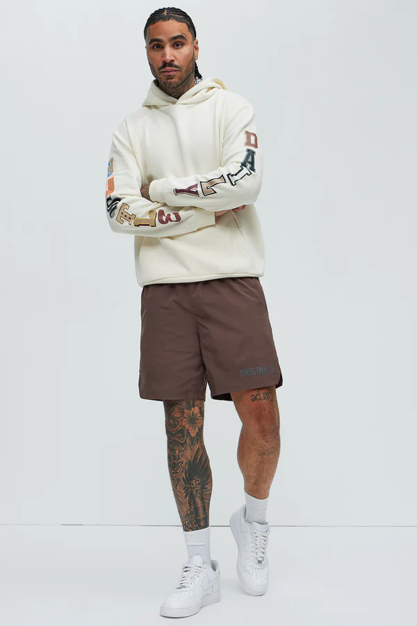 Men's hustle daily hoodie for vacation by VacationGrabs in cream with colorful sleeve graphics