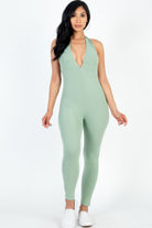 Women wearing a green ribbed bodycon jumpsuit for women with a deep V-neck design