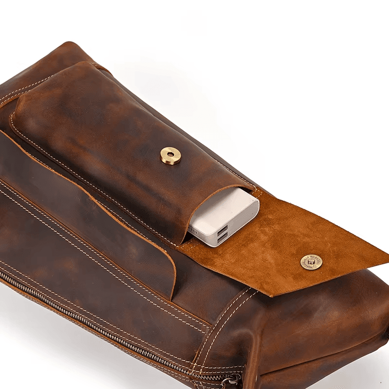 Leather travel backpack for men featuring a spacious interior and a magnetic closure pocket for easy access