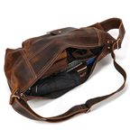 Brown leather travel backpack for men with spacious interior and stylish design