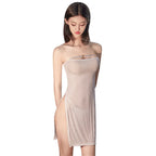 Woman wearing a beige strapless sexy backless mini dress with side slits by VacationGrabs