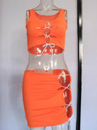 Orange sexy club mini dress with lace-up front and side cutouts on mannequin