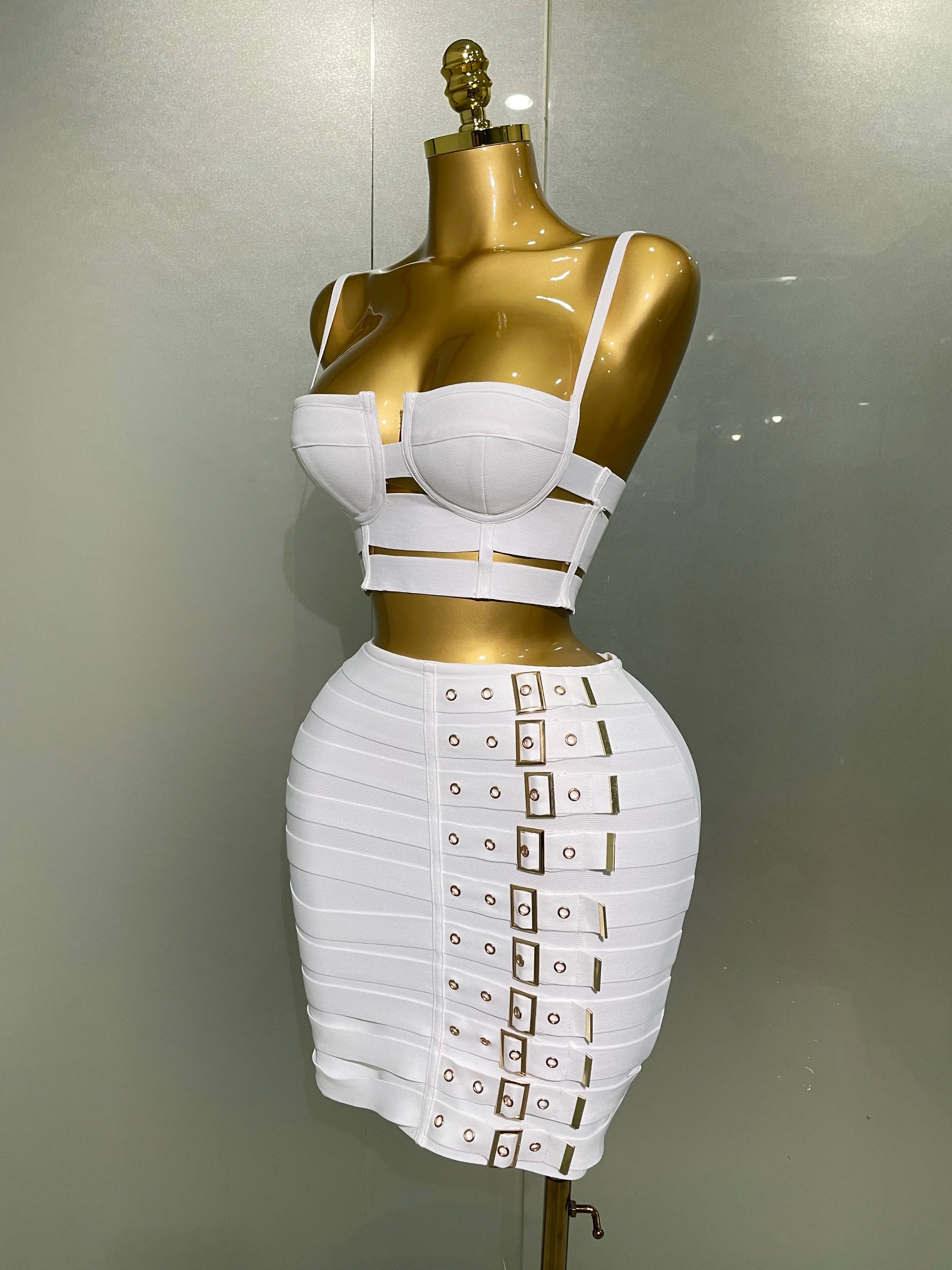 White sexy club outfit for women featuring a strappy crop top and high-waisted skirt with buckle details