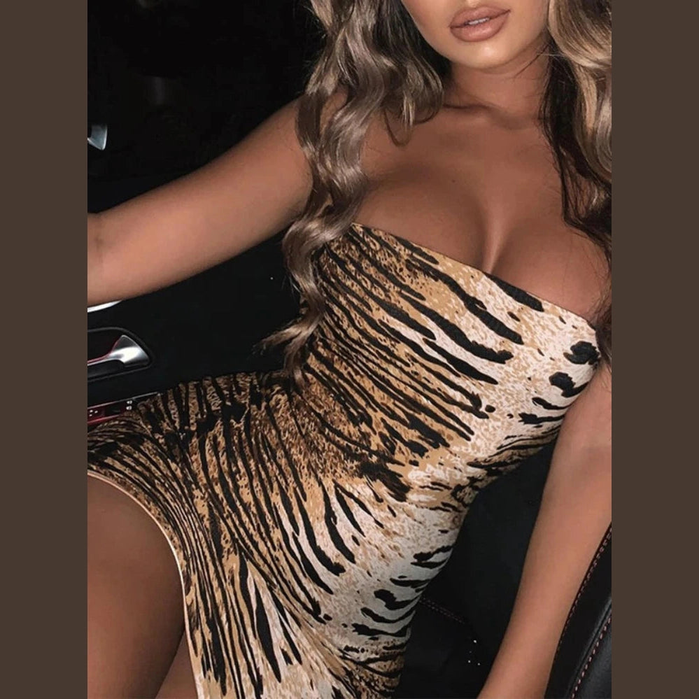 Woman wearing a sexy tiger stripe mini dress with strapless design, sitting in a car seat