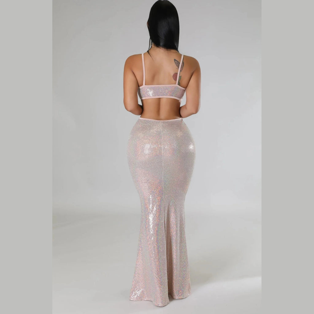 Woman wearing a shiny two-piece sexy vacation maxi dress with thin straps from VacationGrabs