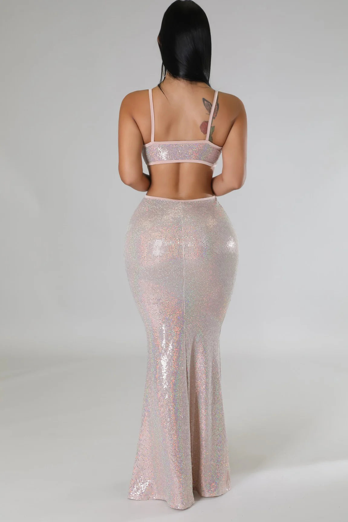 Woman wearing a shiny two-piece sexy vacation maxi dress with thin straps from VacationGrabs