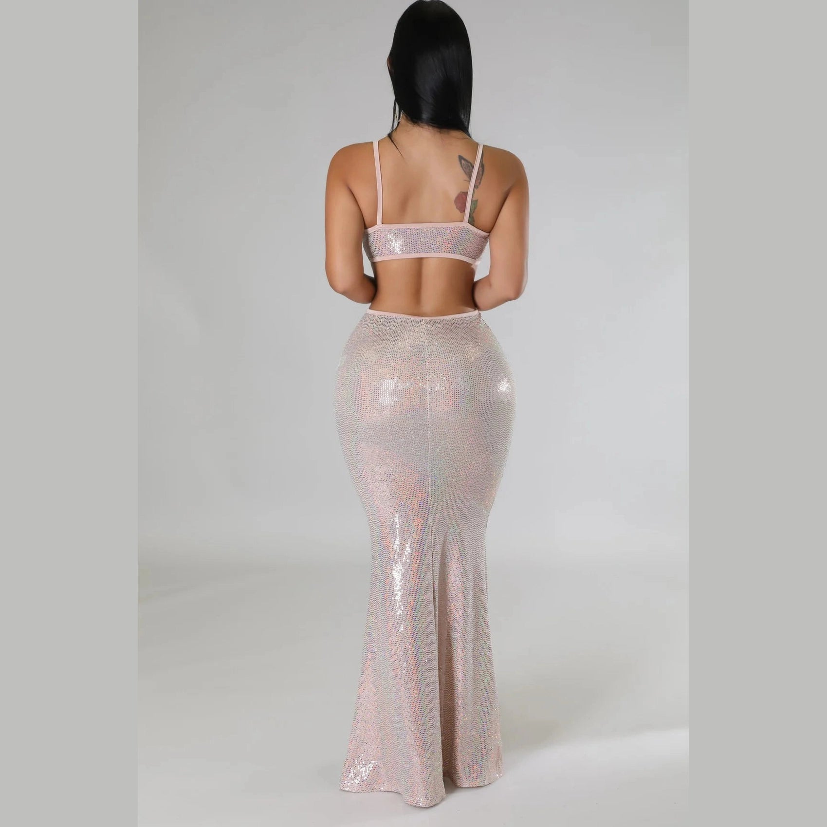 Woman wearing a shiny two-piece sexy vacation maxi dress with thin straps from VacationGrabs