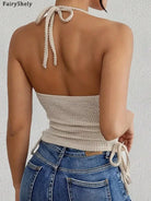 Back view of a woman wearing a beige sleeveless bodycon halter top for women paired with blue jeans