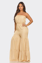 Elegant strapless vacation jumpsuit in soft beige with flared legs and a comfortable fit