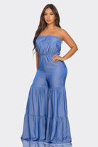 Stylish blue strapless vacation jumpsuit with flared bottoms for comfortable summer outings