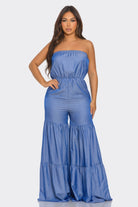 Stylish strapless vacation jumpsuit in blue with a wide-leg design and tiered ruffles