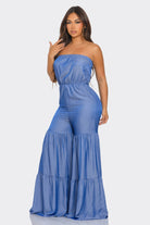 Blue strapless vacation jumpsuit with flowing tiers for stylish summer outings
