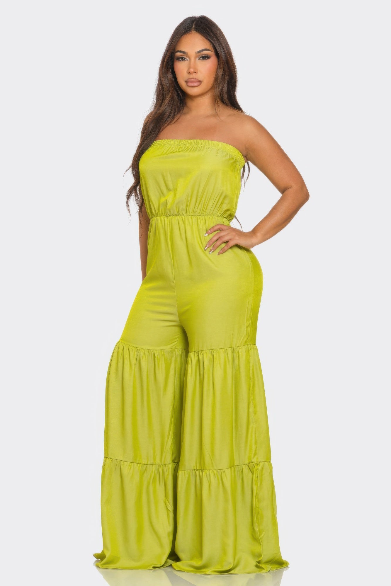 Bright green strapless vacation jumpsuit with a flowing tiered design for summer outings
