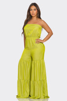 Bright green strapless vacation jumpsuit with a flowing tiered design for summer outings