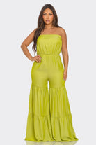 Strapless vacation jumpsuit in bright green with tiered flared legs for stylish summer outings